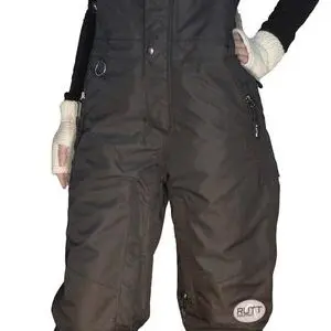 Person wearing black snow overalls and boots.