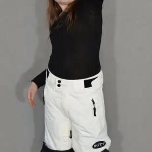 Child posing in winter clothing indoors.