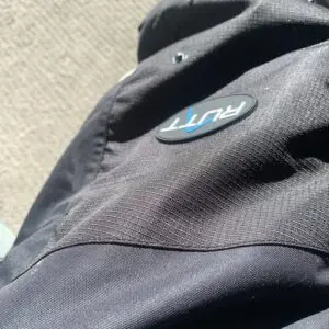Jacket with "RUNT" logo in sunlight.