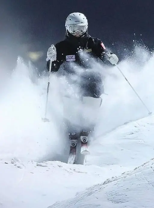 Skier navigating through snow in winter gear.